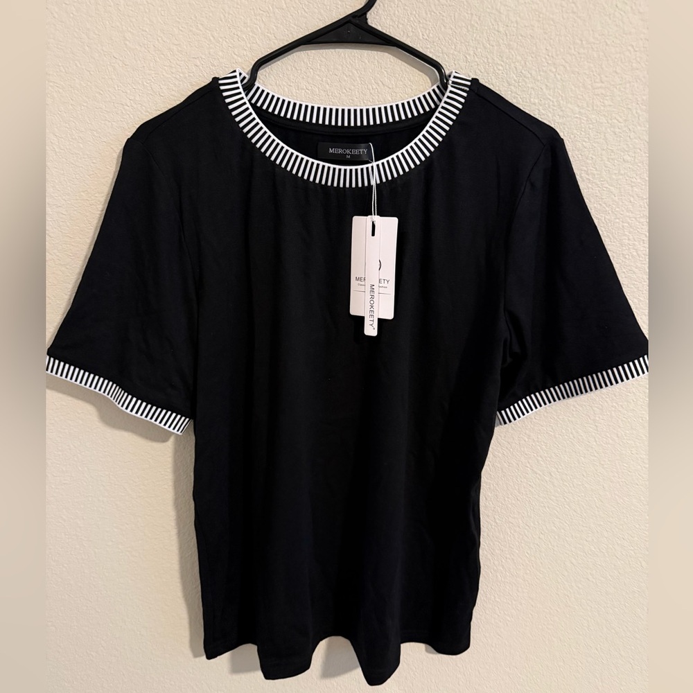 Women’s tshirt with black/white stripe decorative trim.